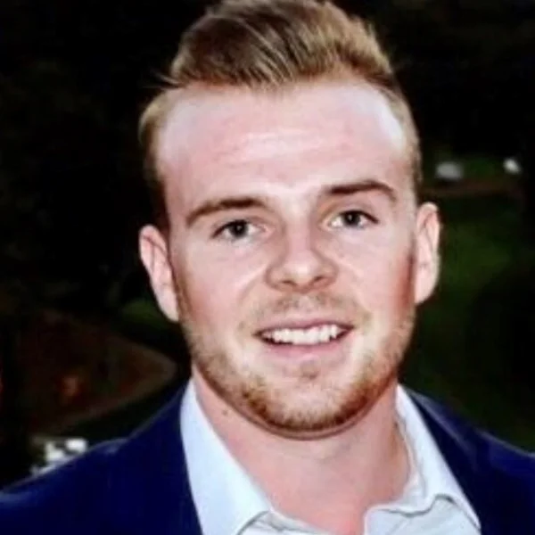 Headshot of man with blonde hair smiling